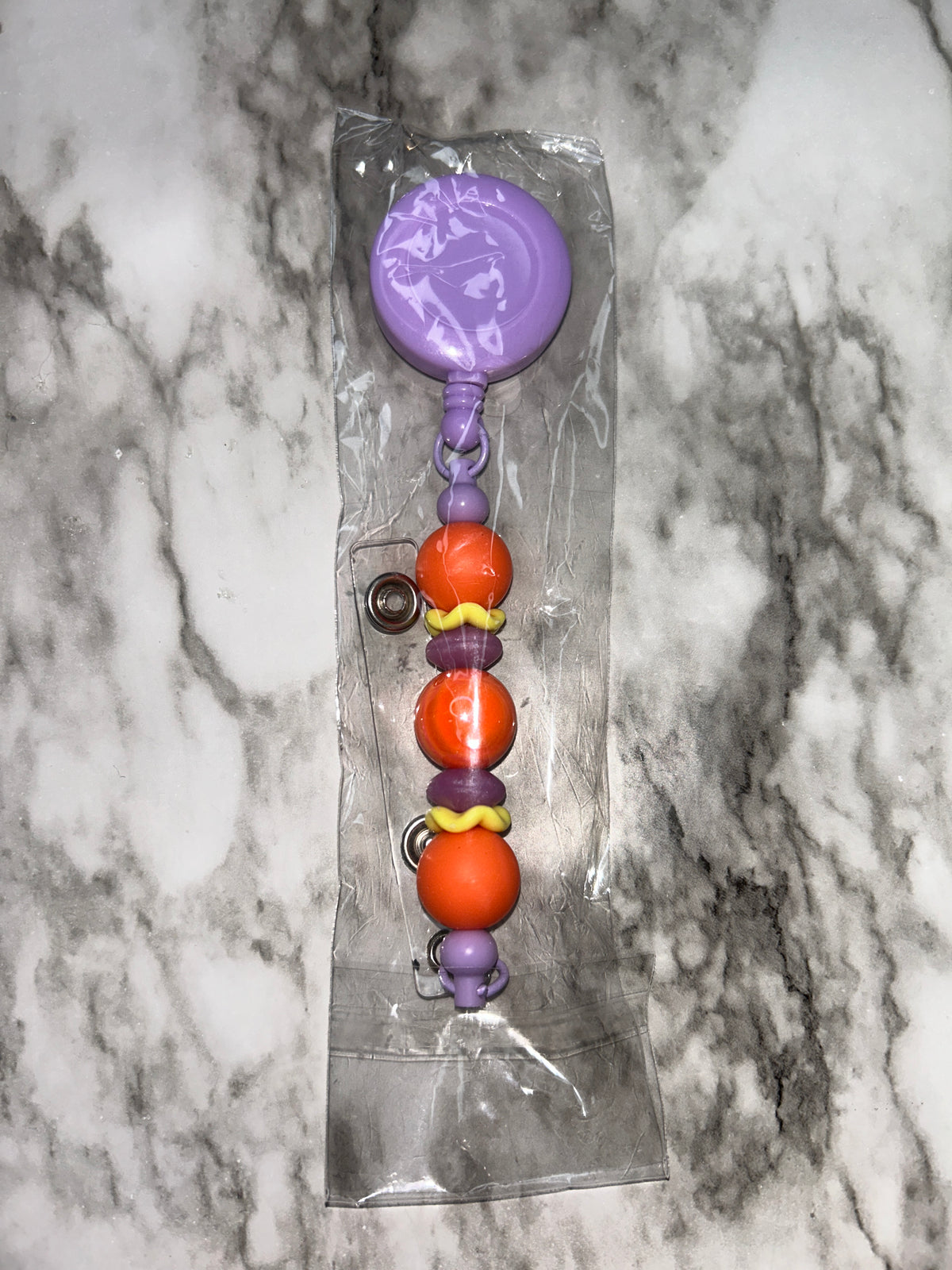 Badge Reel Purple Orange